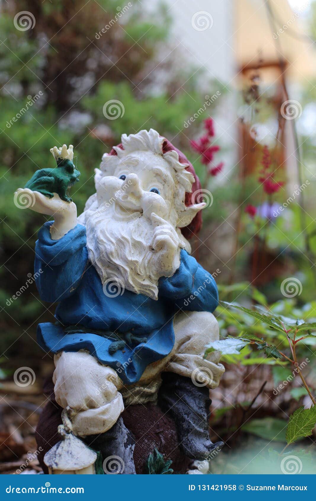 decorative ceramic garden ornaments amidst flower garden stock photo