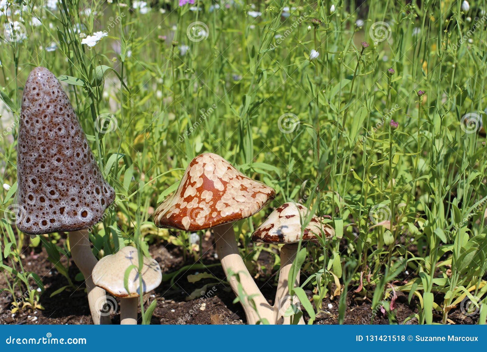 decorative ceramic garden ornaments amidst flower garden stock photo