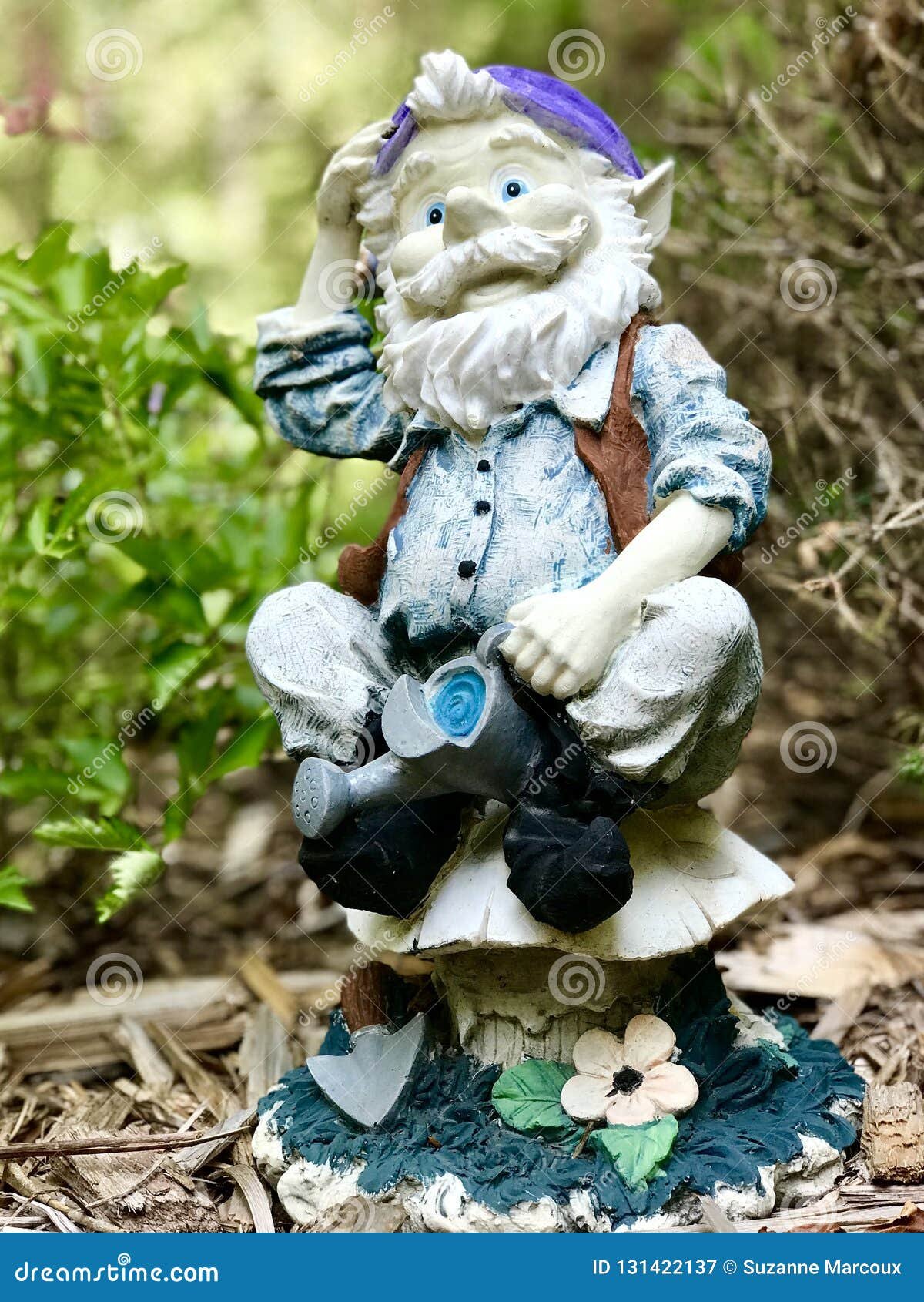 decorative ceramic garden ornaments amidst flower garden stock image